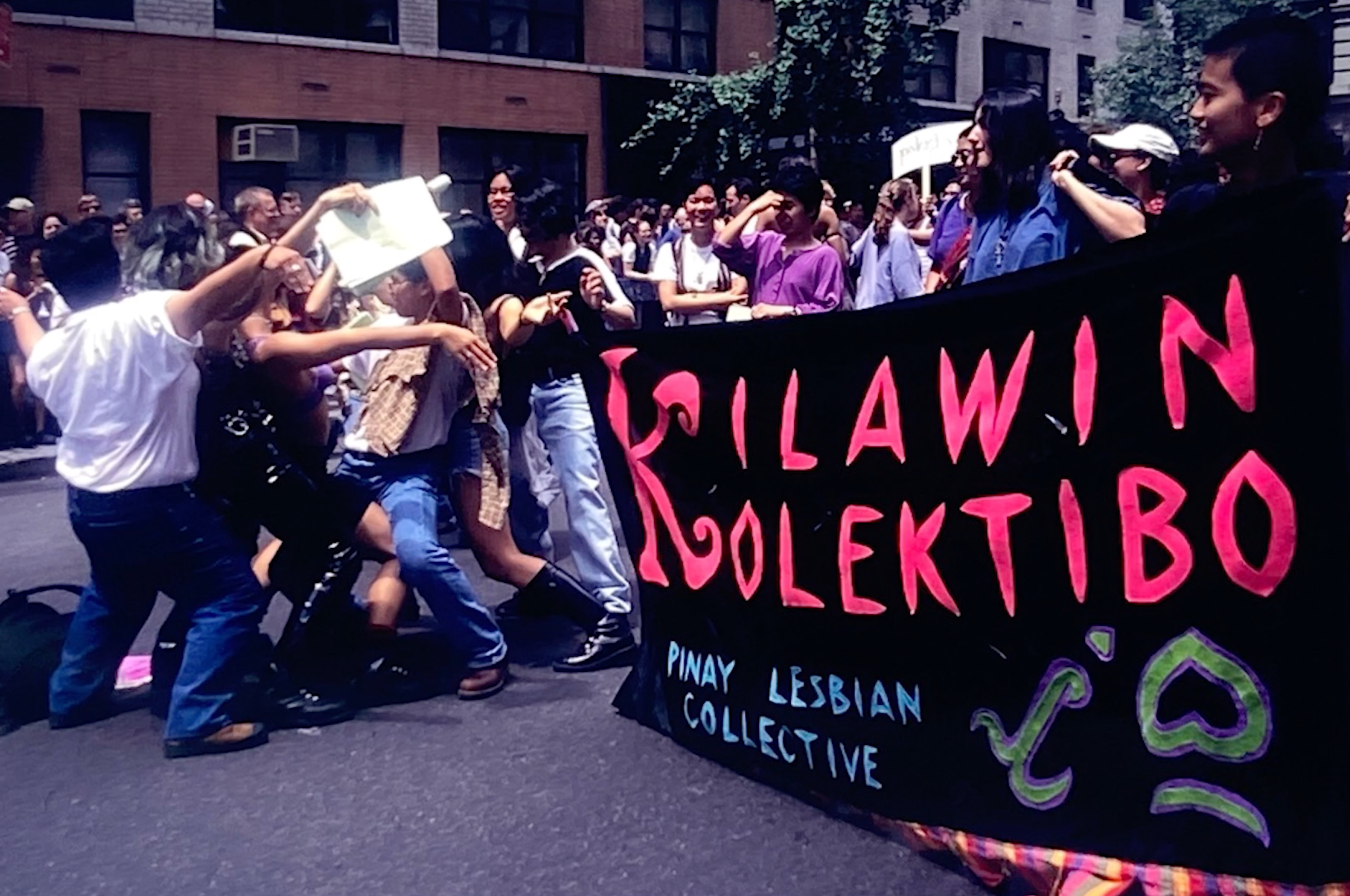 A group of people hold a banner.