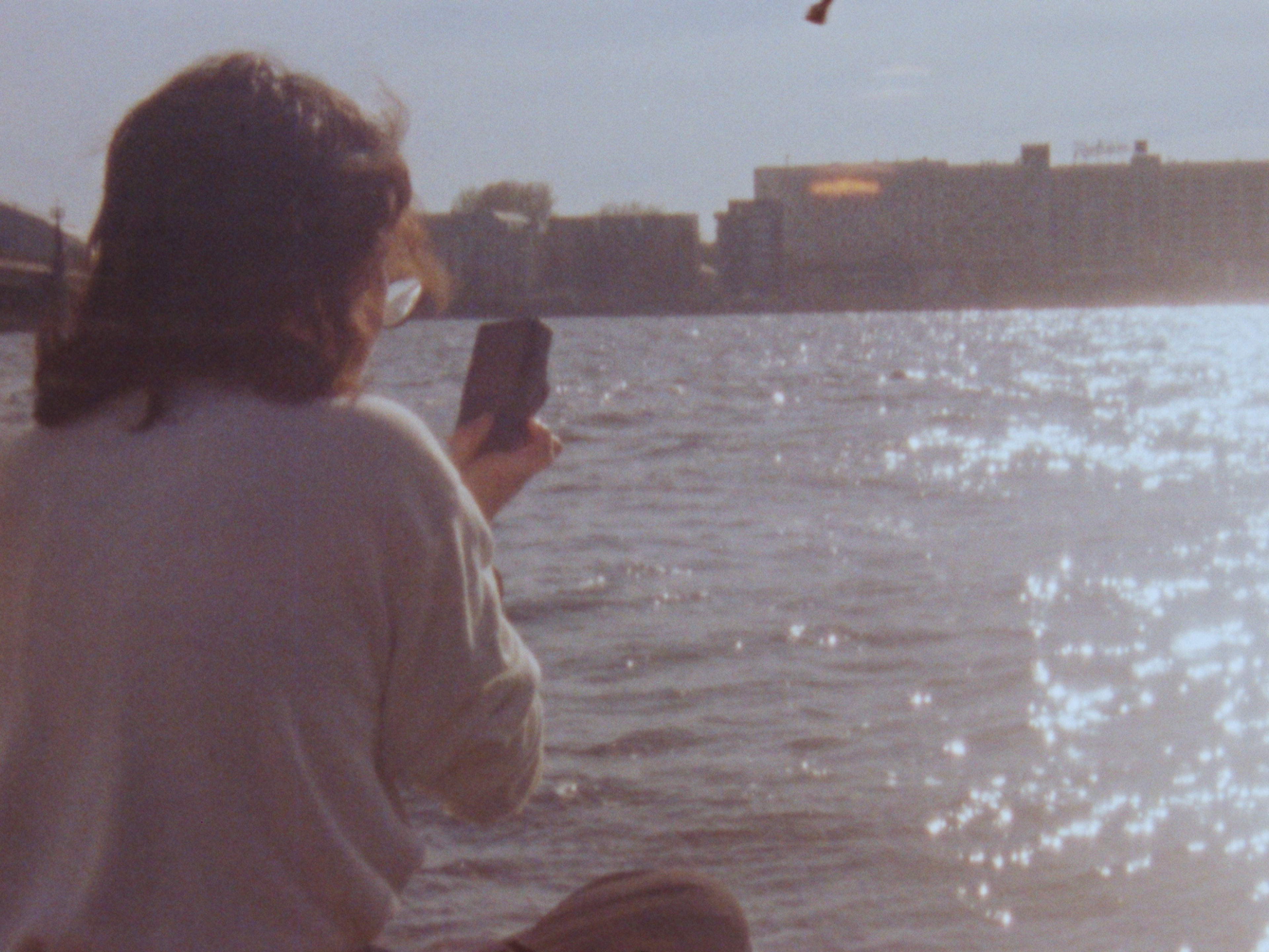 A person takes a photo of the water.