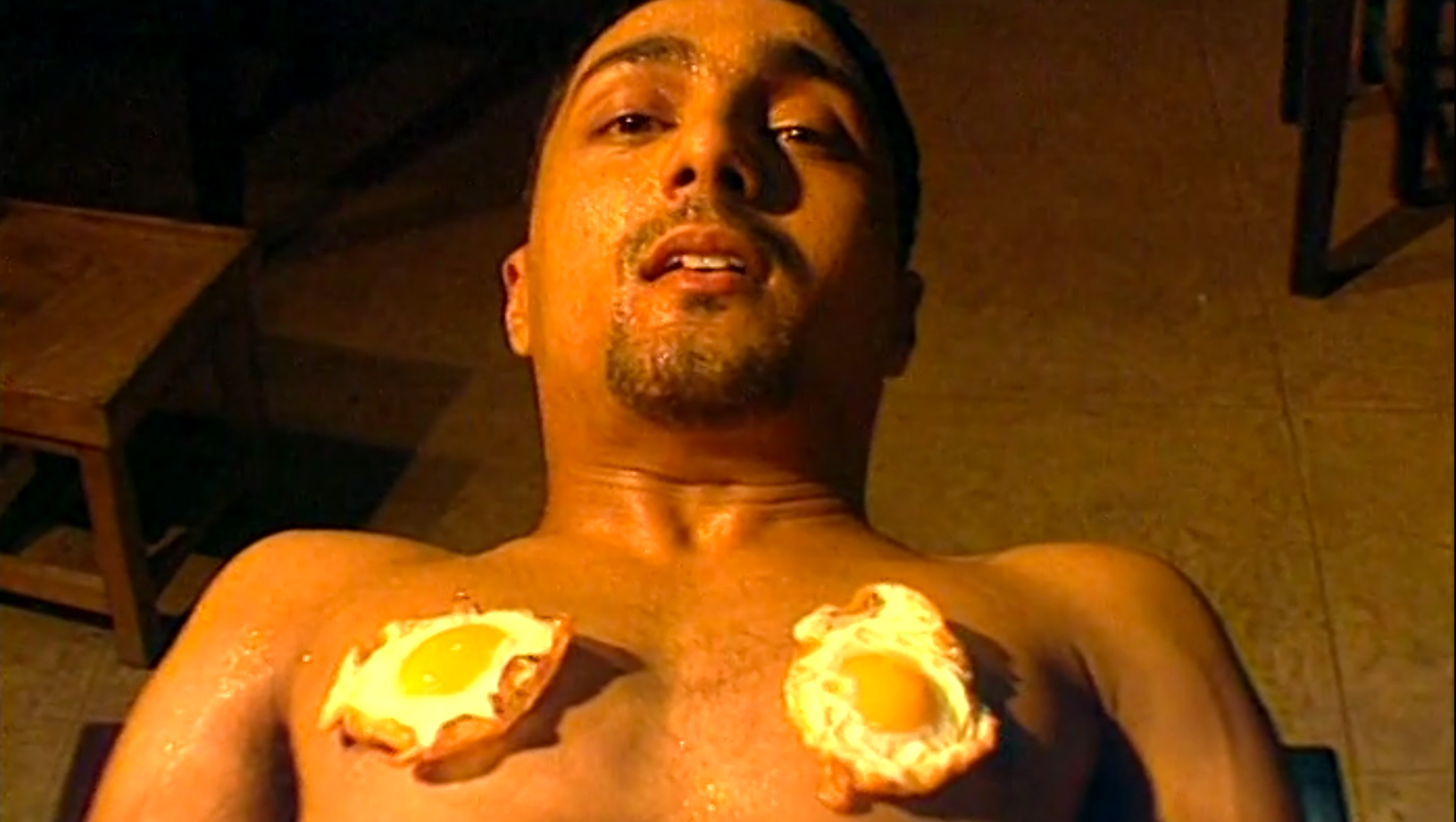 A man with a fried egg on each nipple.