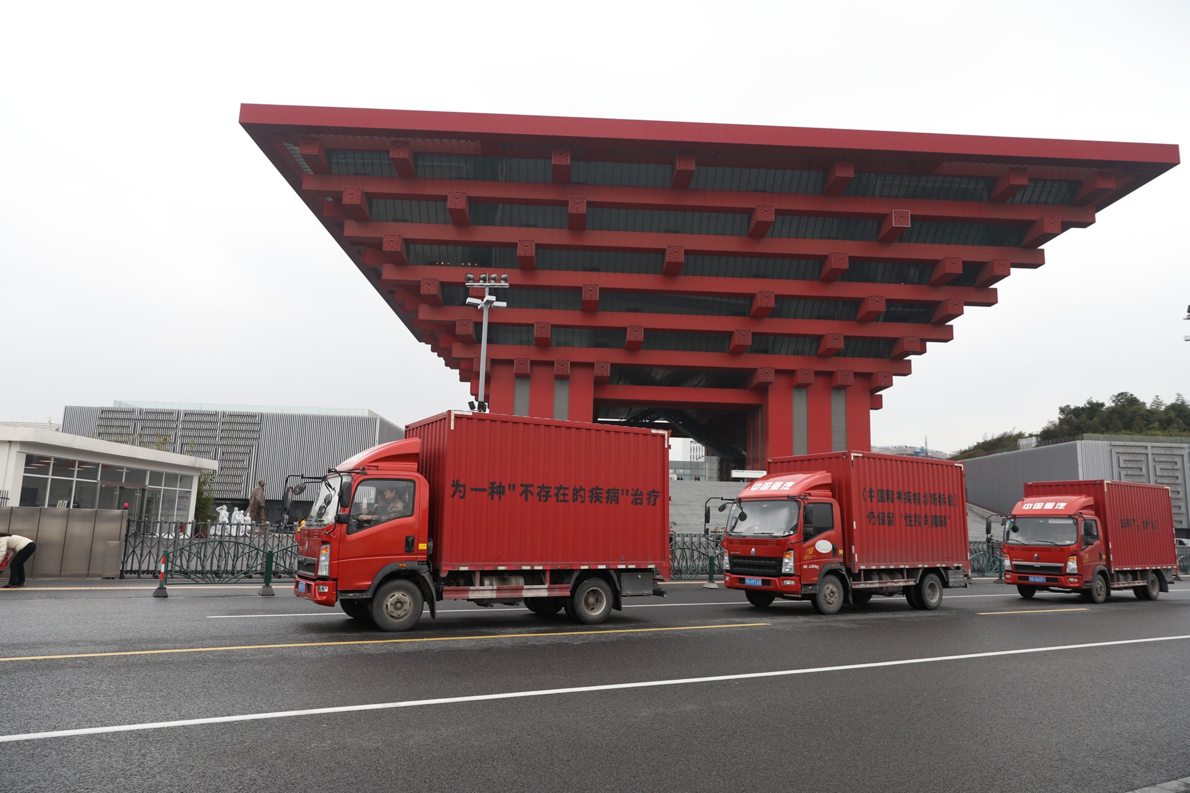 Three red trucks in a row.