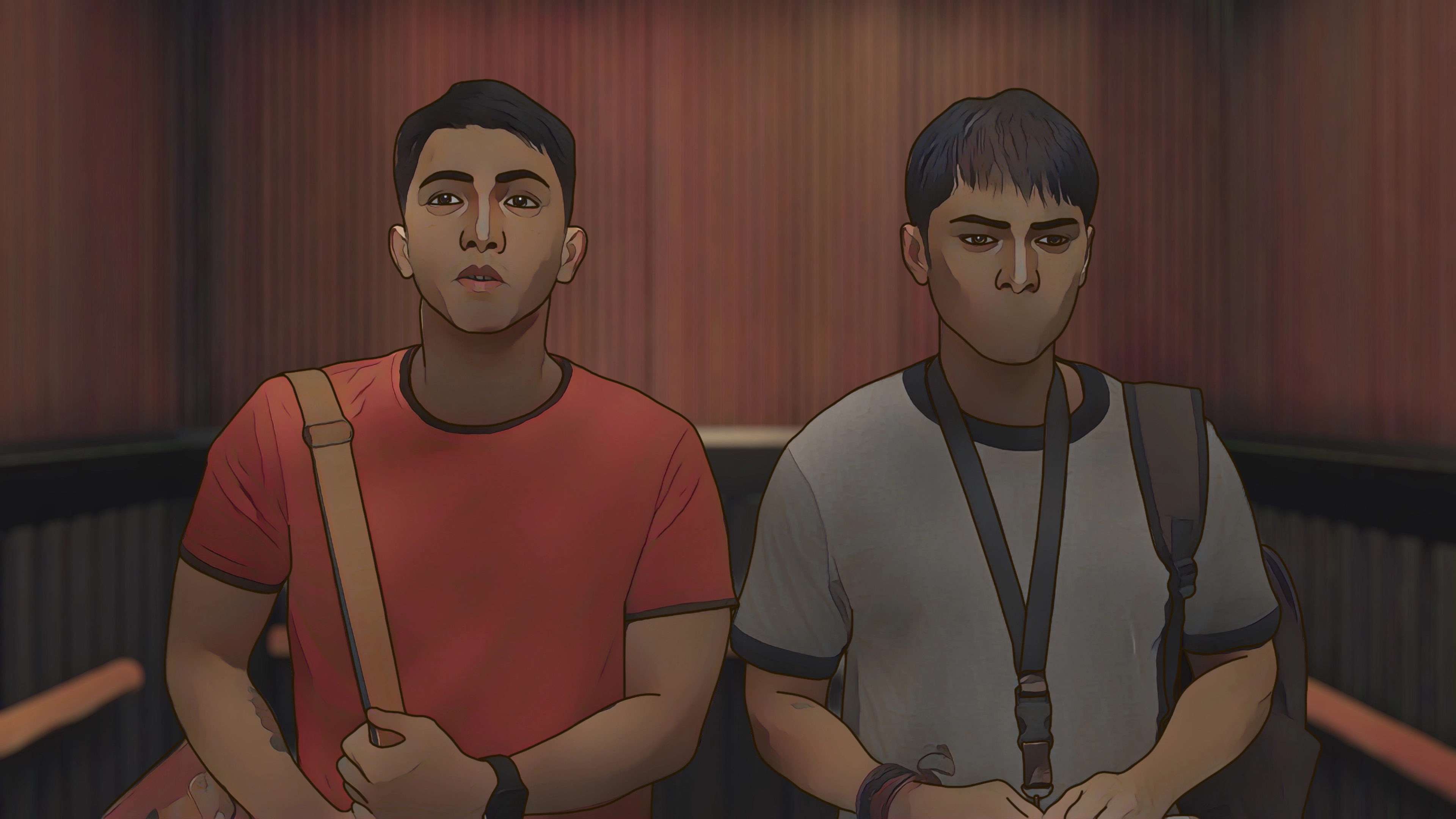 Two animated young men sitting side by side with bags over their shoulders in a dimly lit interior.