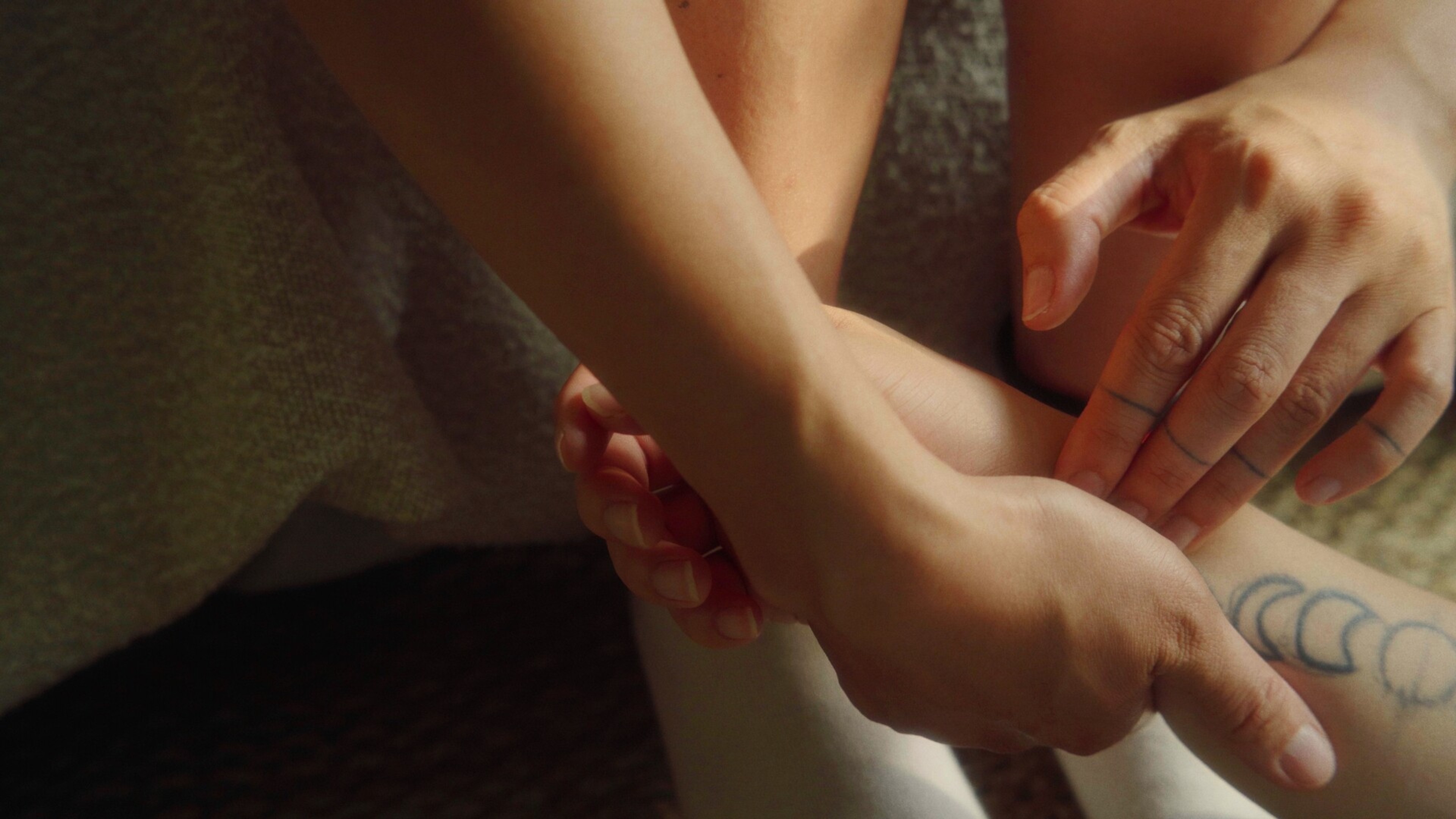 Three interlacing hands