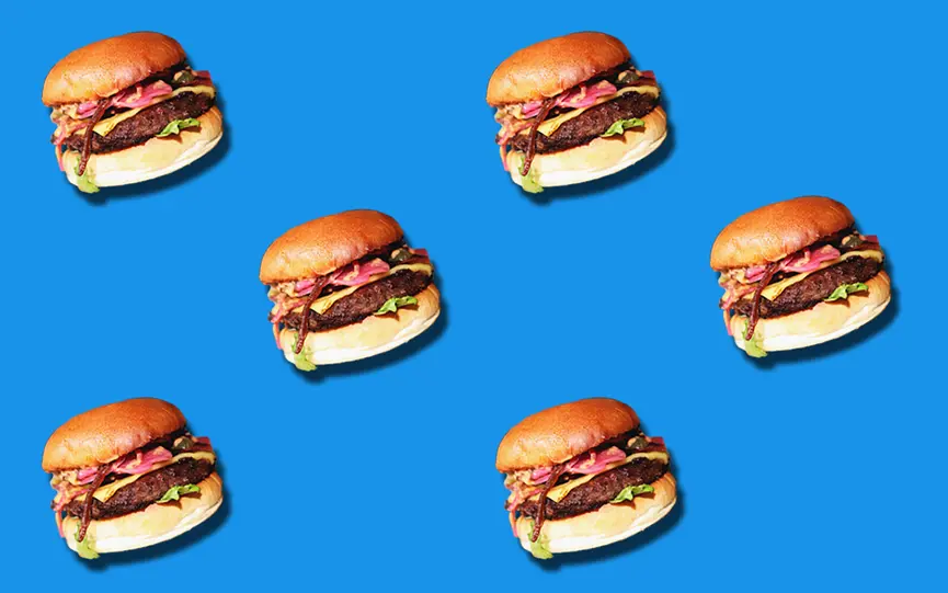 Six vegan burgers on a blue background