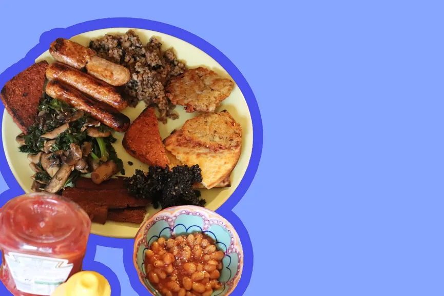 Scottish vegan fry-up breakfast on plate, on a blue background.