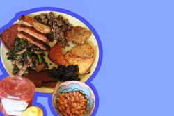 Scottish vegan fry-up breakfast on plate, on a blue background.