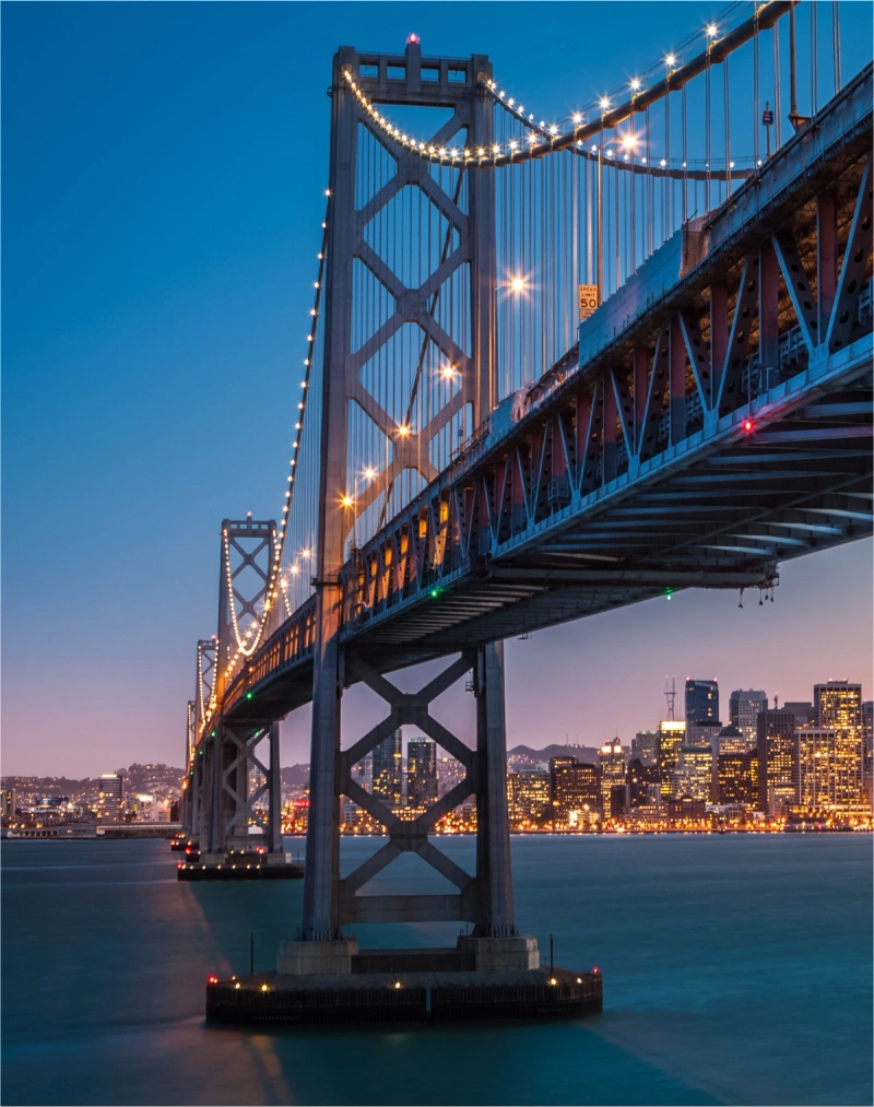 The San Francisco-Oakland Bay Bridge lit up a night