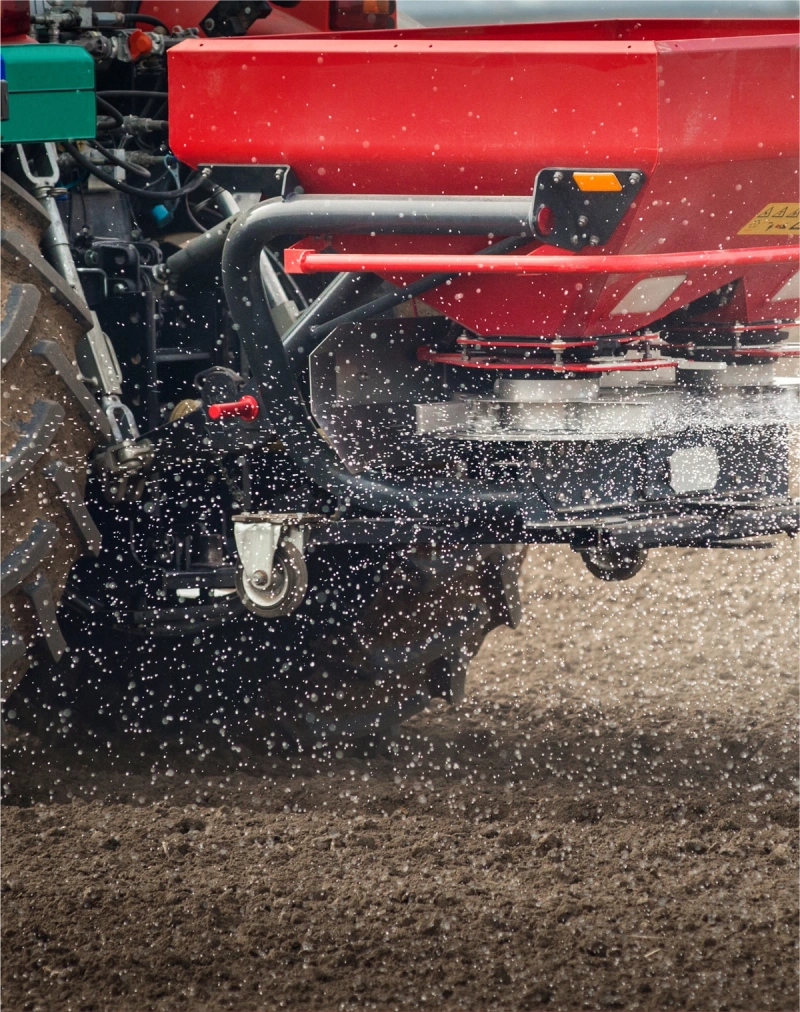 A tractor spreading fertilizer