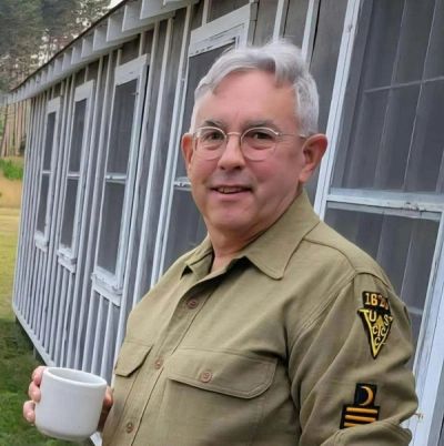 Phil Naud in a CCC uniform outside a camp barracks