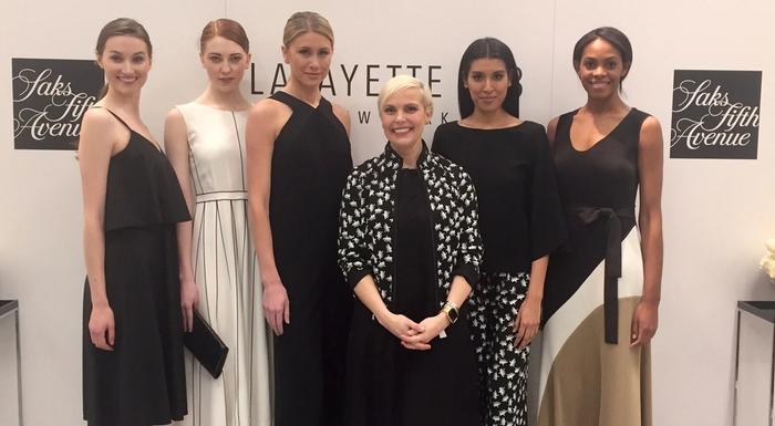 Jenn Rogien standing with models in front of a backdrop for Lafayette 148 New York