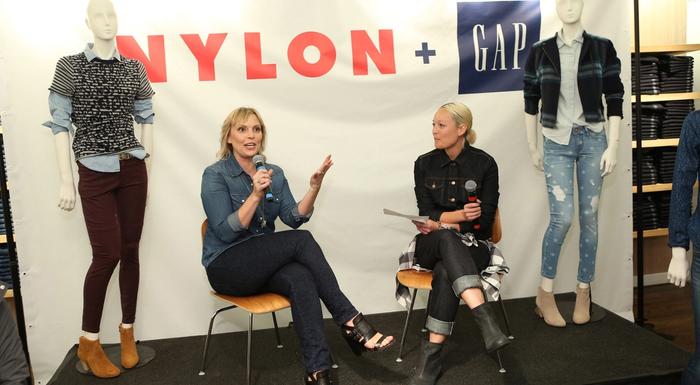 Jenn Rogien speaks with Rachel Wang in front of a sign reading Nylon + Gap