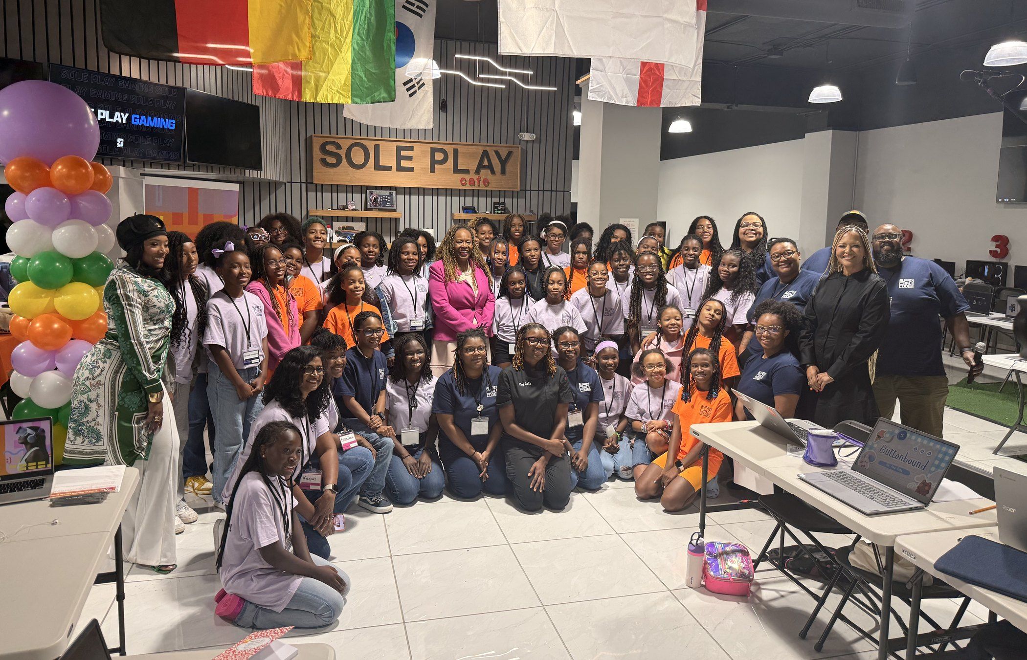 Girls, staff and guests gather for a group photo at the Atlanta International Day of the Girl event