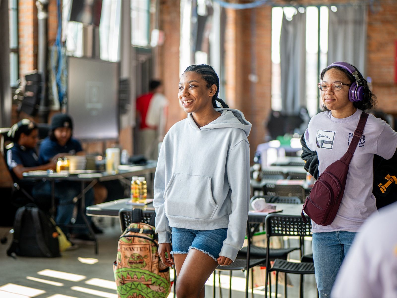 Zeriah, 12, walking through the camp space in a gray hoodie