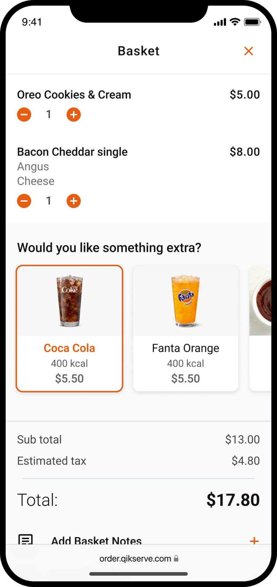 Phone basket screen listing two items with quantity controls and a 'Would you like something extra?' row offering soft drinks above the total