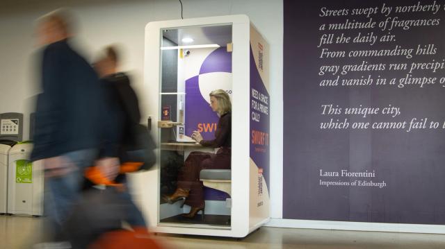 A business traveller working in a SWURF pod at Edinburgh Airport