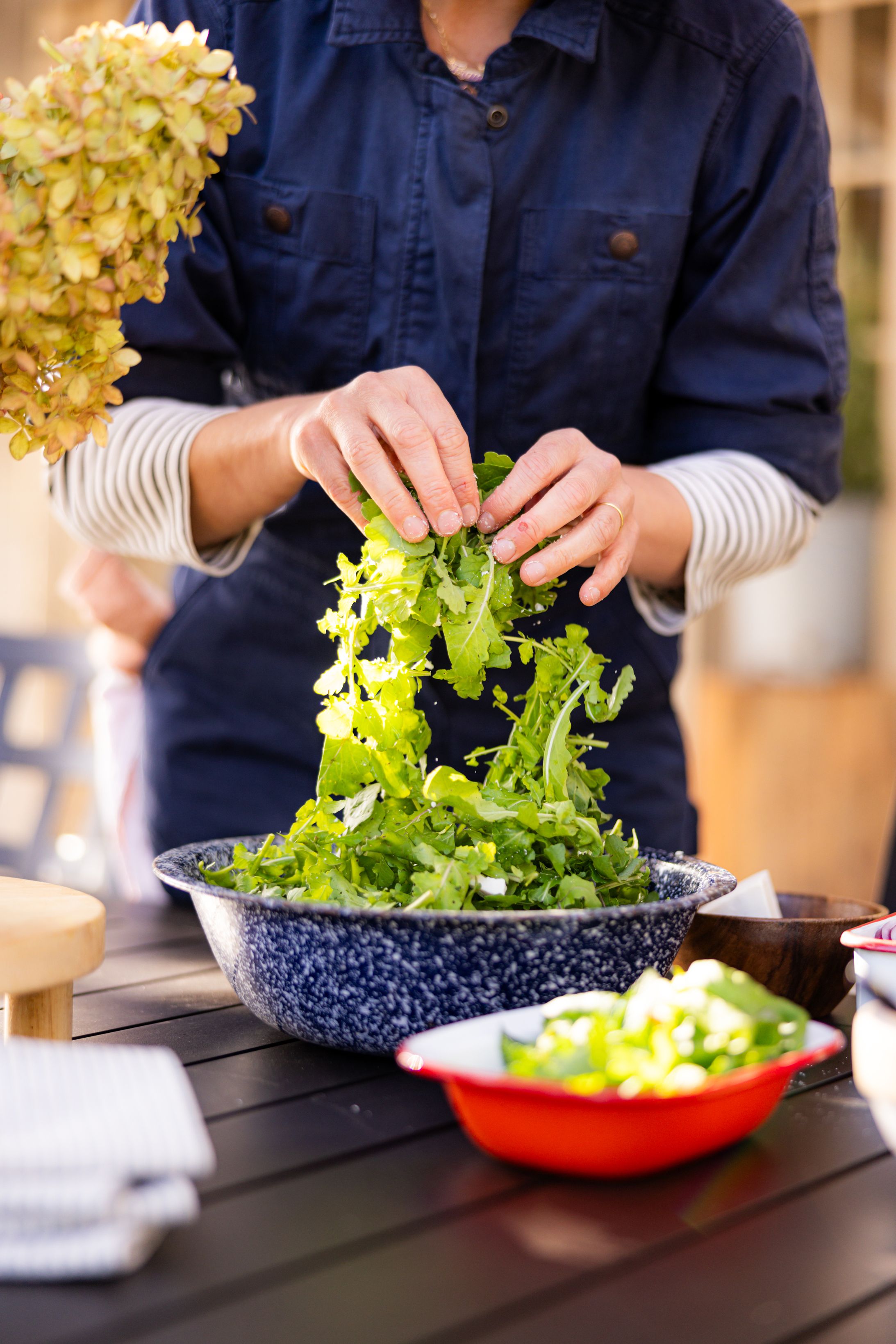 A woman making a salad 