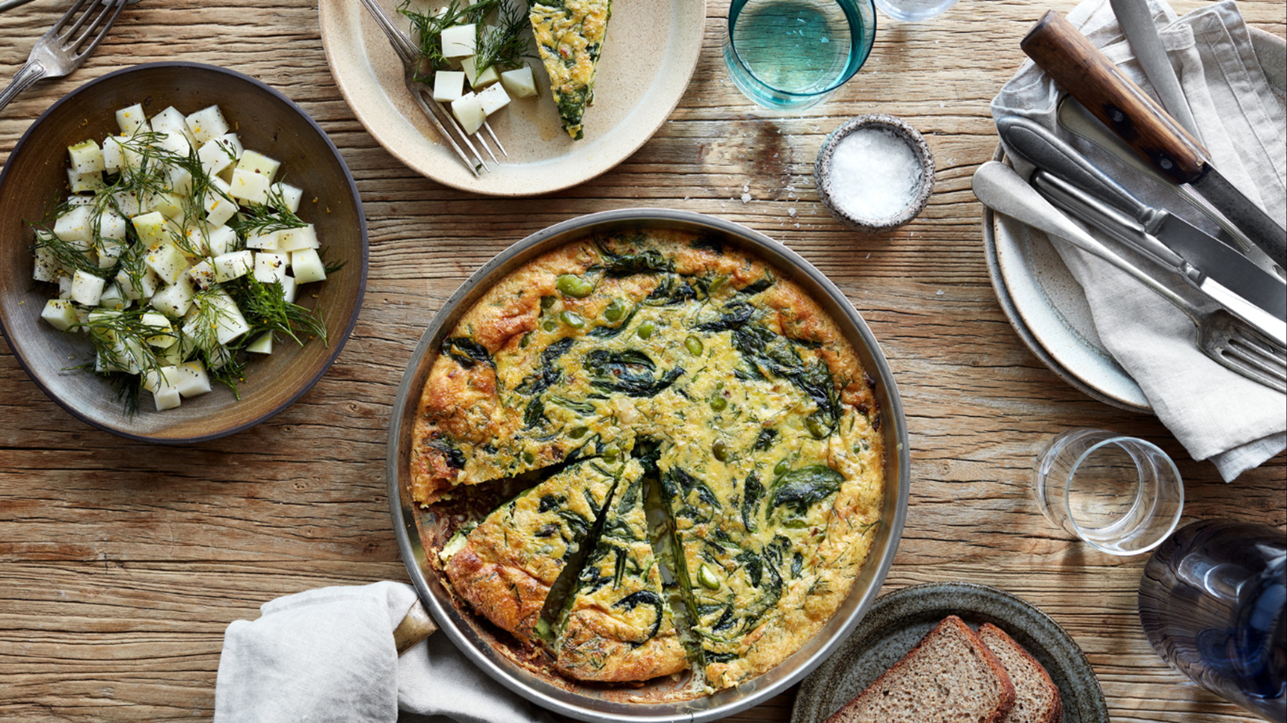 Æggekage med to slags bønner, spinat og dild serveret med glaskålssalat og hestebønnedip