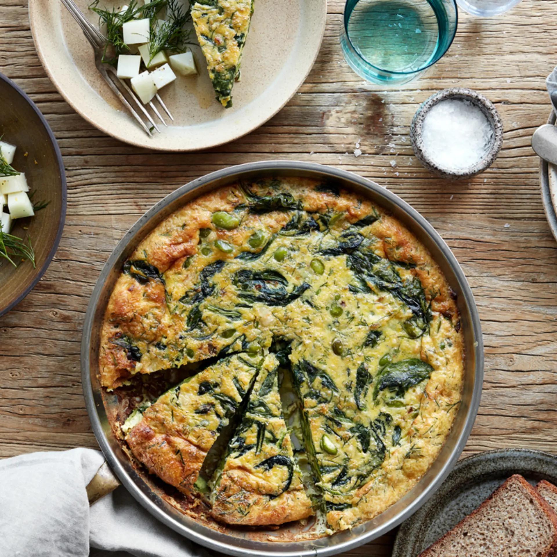 Æggekage med to slags bønner, spinat og dild serveret med glaskålssalat og hestebønnedip