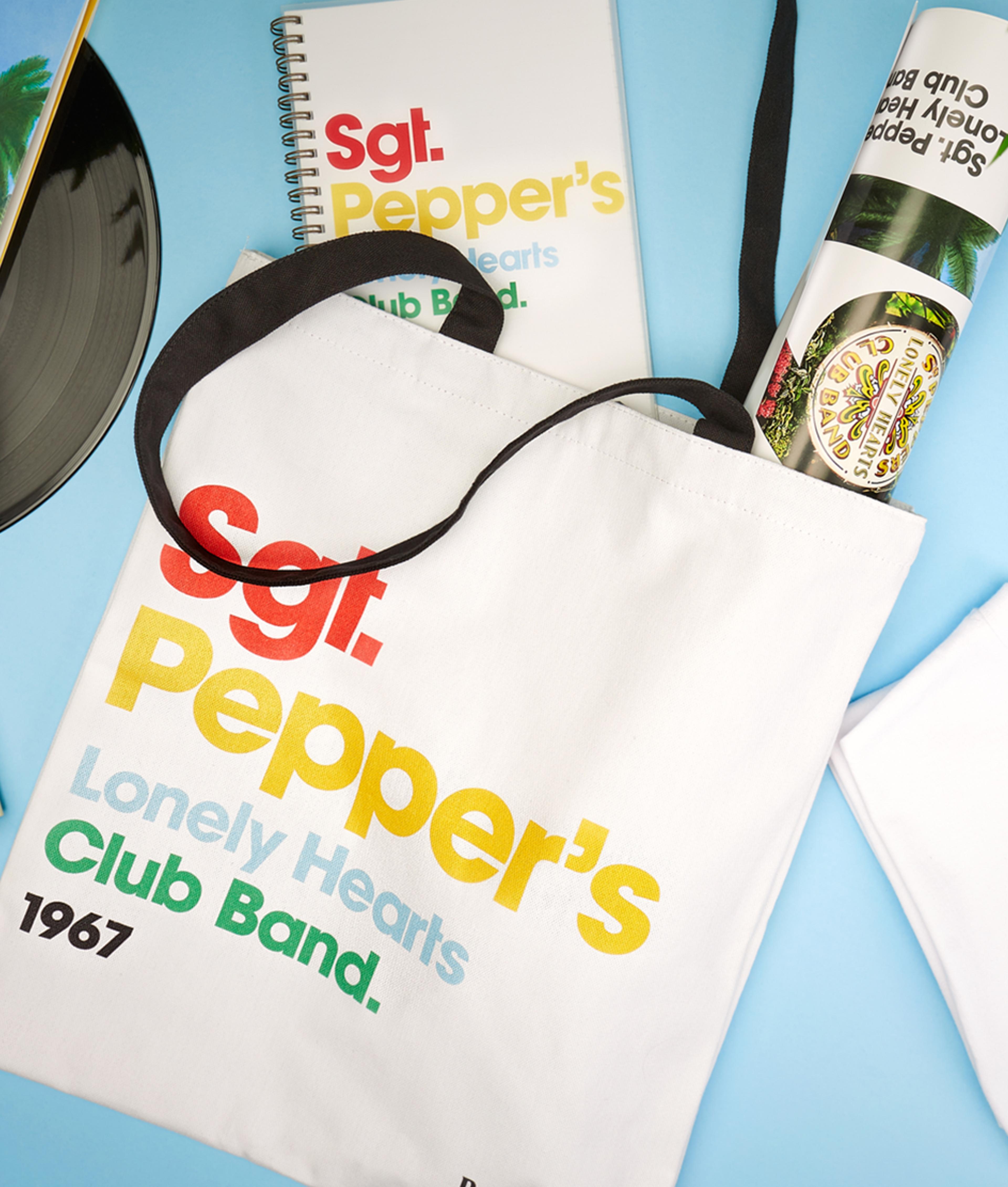 Beatles Merchandise Beatles merchandise relating to Sergeant Pepper's lonely hearts club. Tote bag, notebook, rolled up poster.