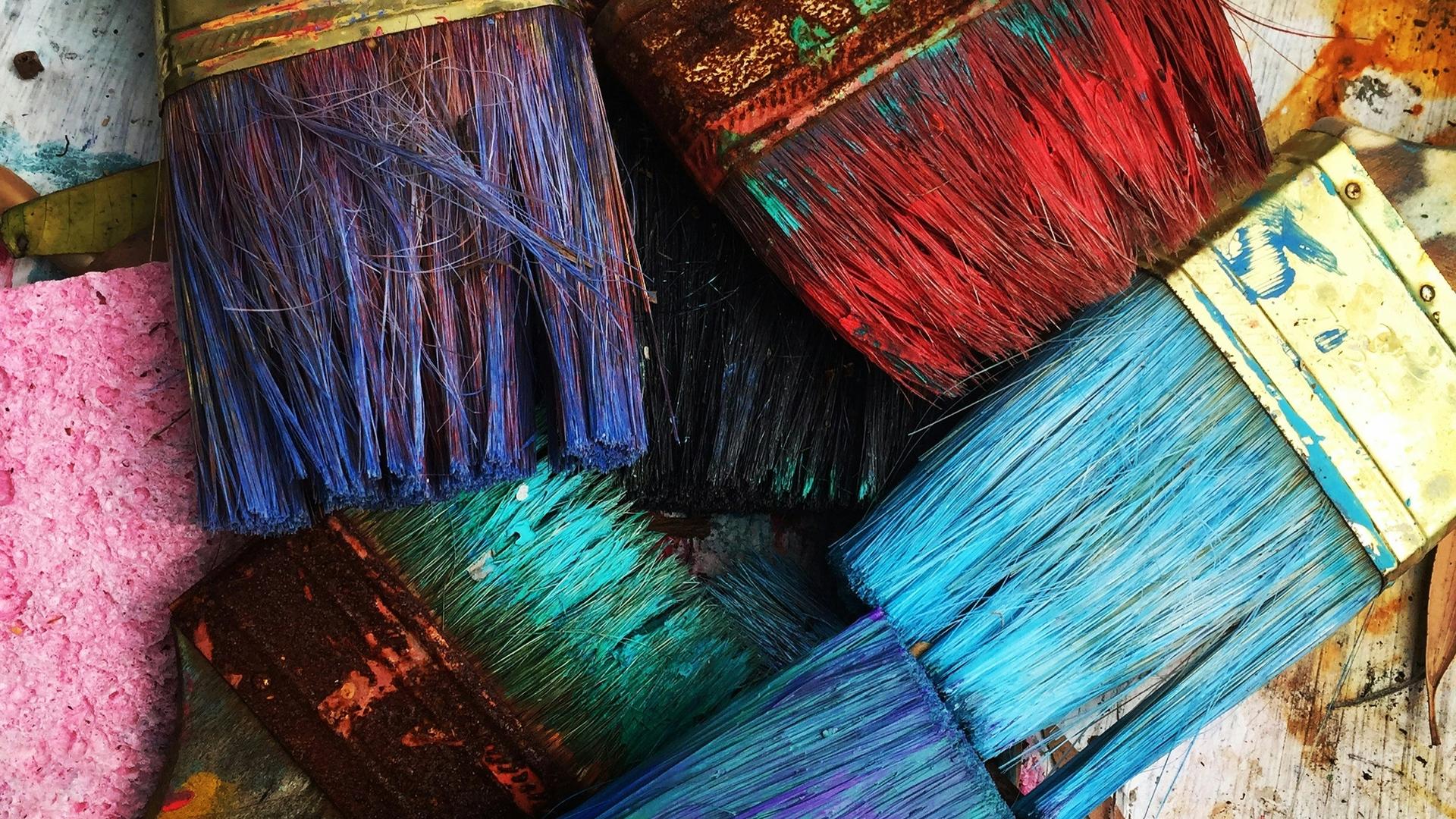 Photo of paint brushes in different colors.