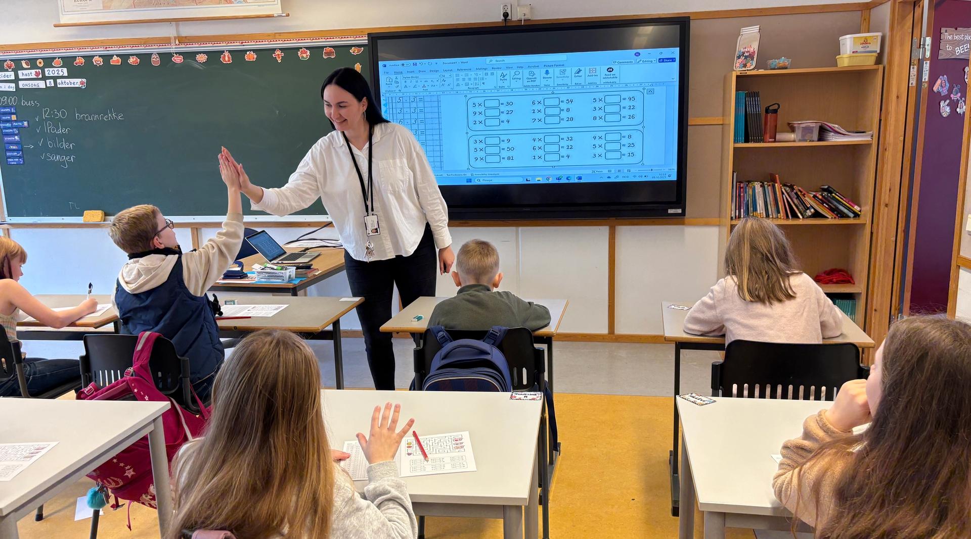 Kvinnelig lærer i klasserom med skoleelever