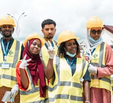 Men and women wearing face masks, reflective vests and helmets
