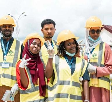 Men and women wearing face masks, reflective vests and helmets 