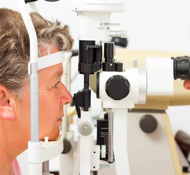 En optiker som ser inn i øynene på en kvinne
