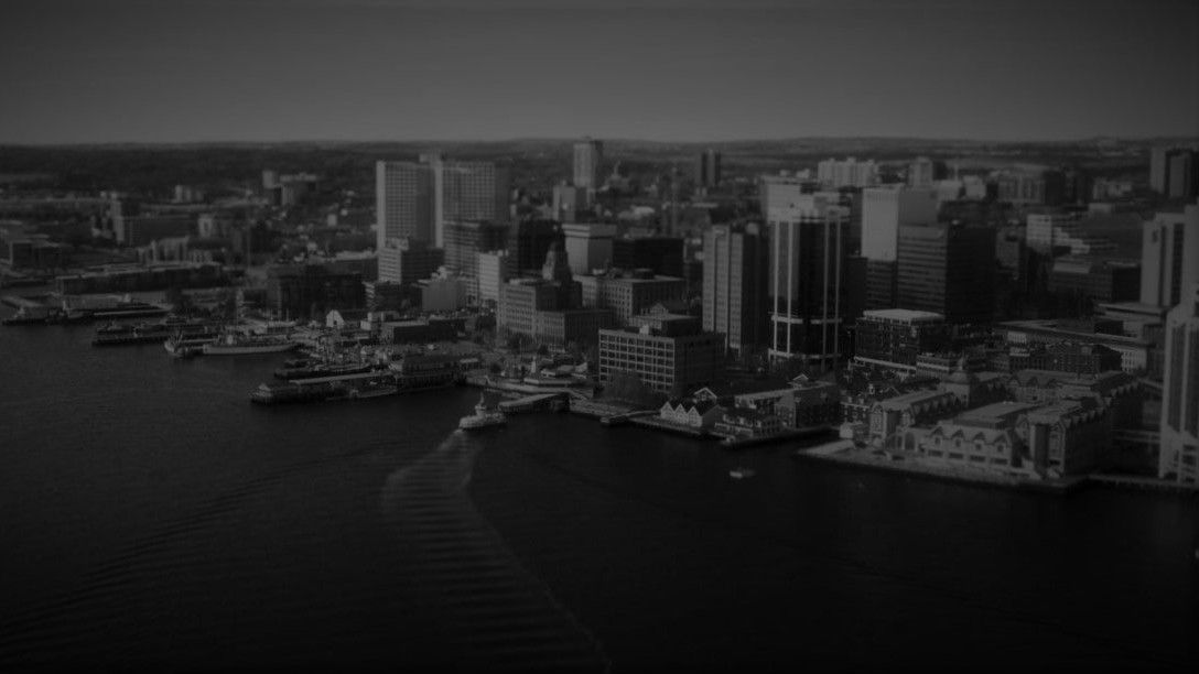 A black and white photo of the city and coast of Halifax, NS.