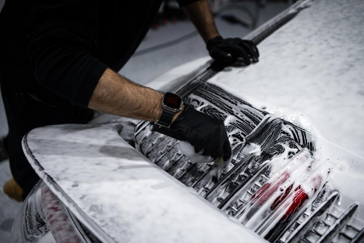 Rear of a Porsche 911 being hand cleaned in snow foam