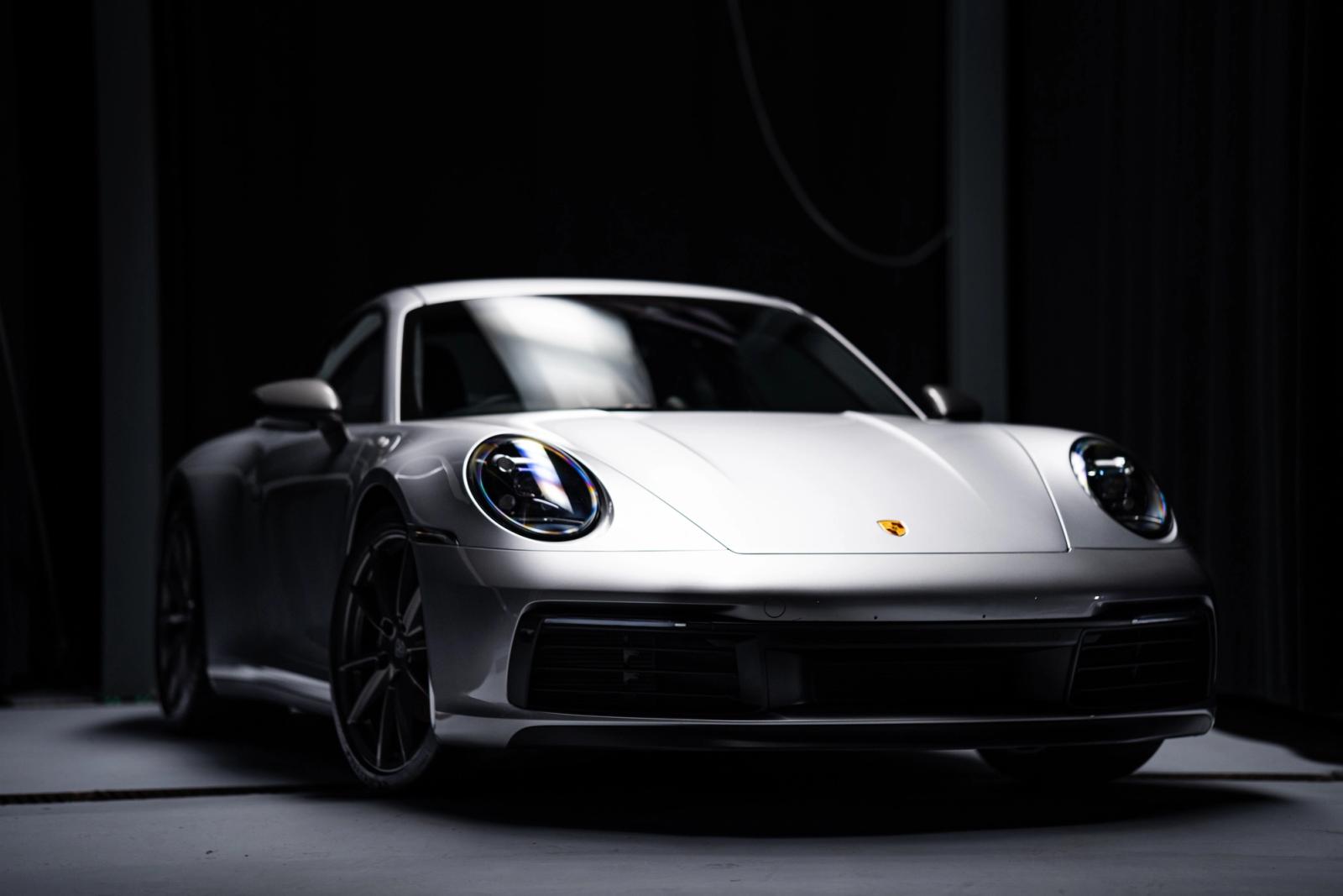 Silver Porsche 911 Carrera T under studio lighting after paint protection at Charlie Detailing