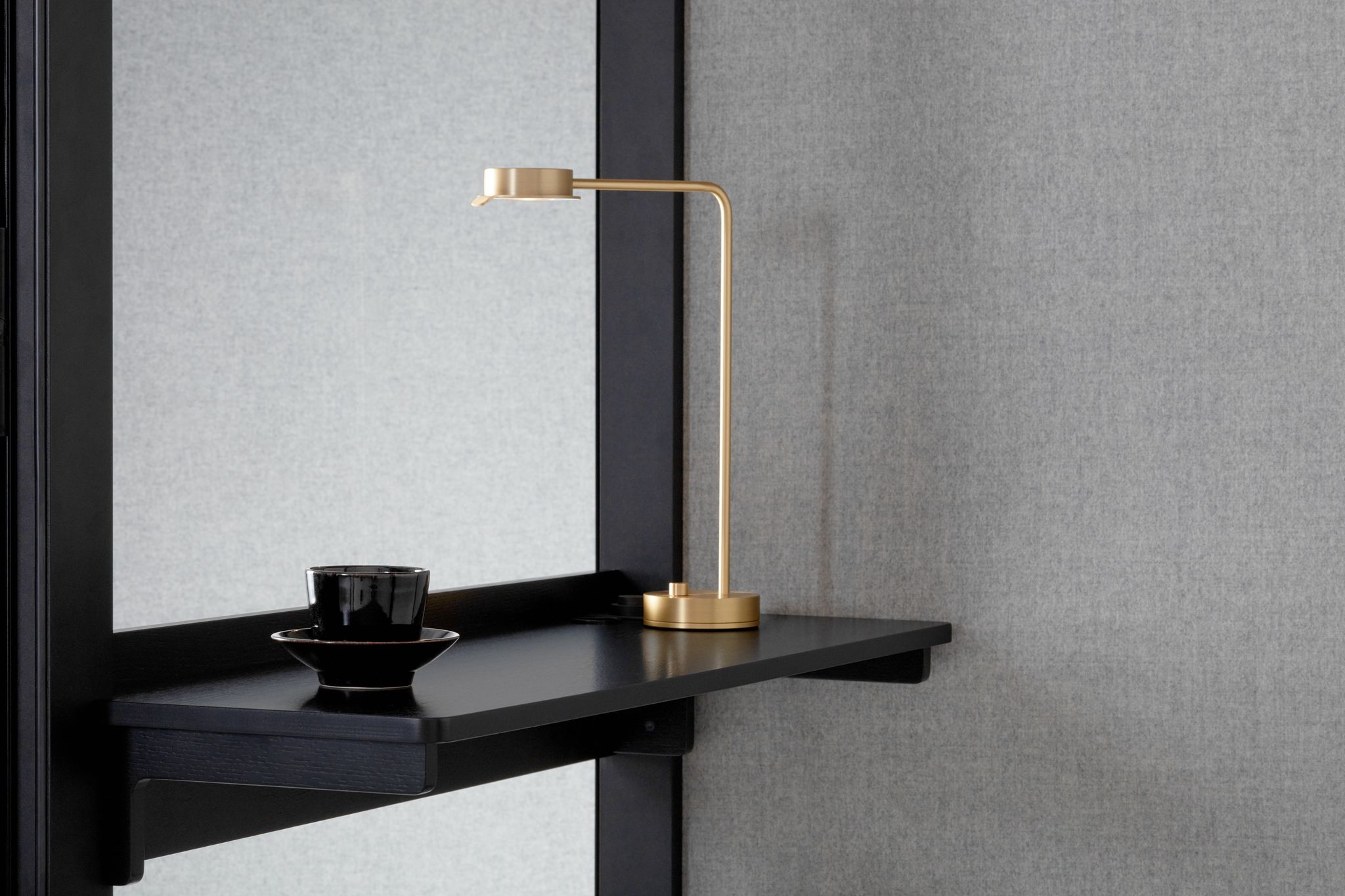 Small dark Zen Pod shelf with gold lamp and black cup