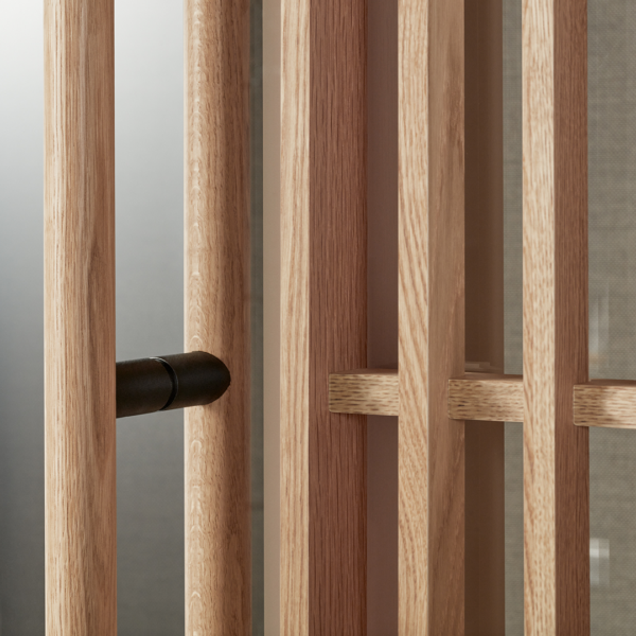 Close-up of wooden slats and black handle detail on a Zen Pod by Abstracta.