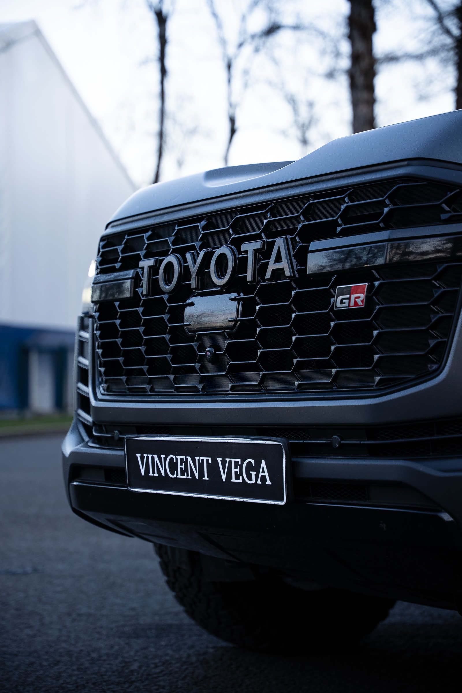 Front grille of a Toyota GR with dealer plate