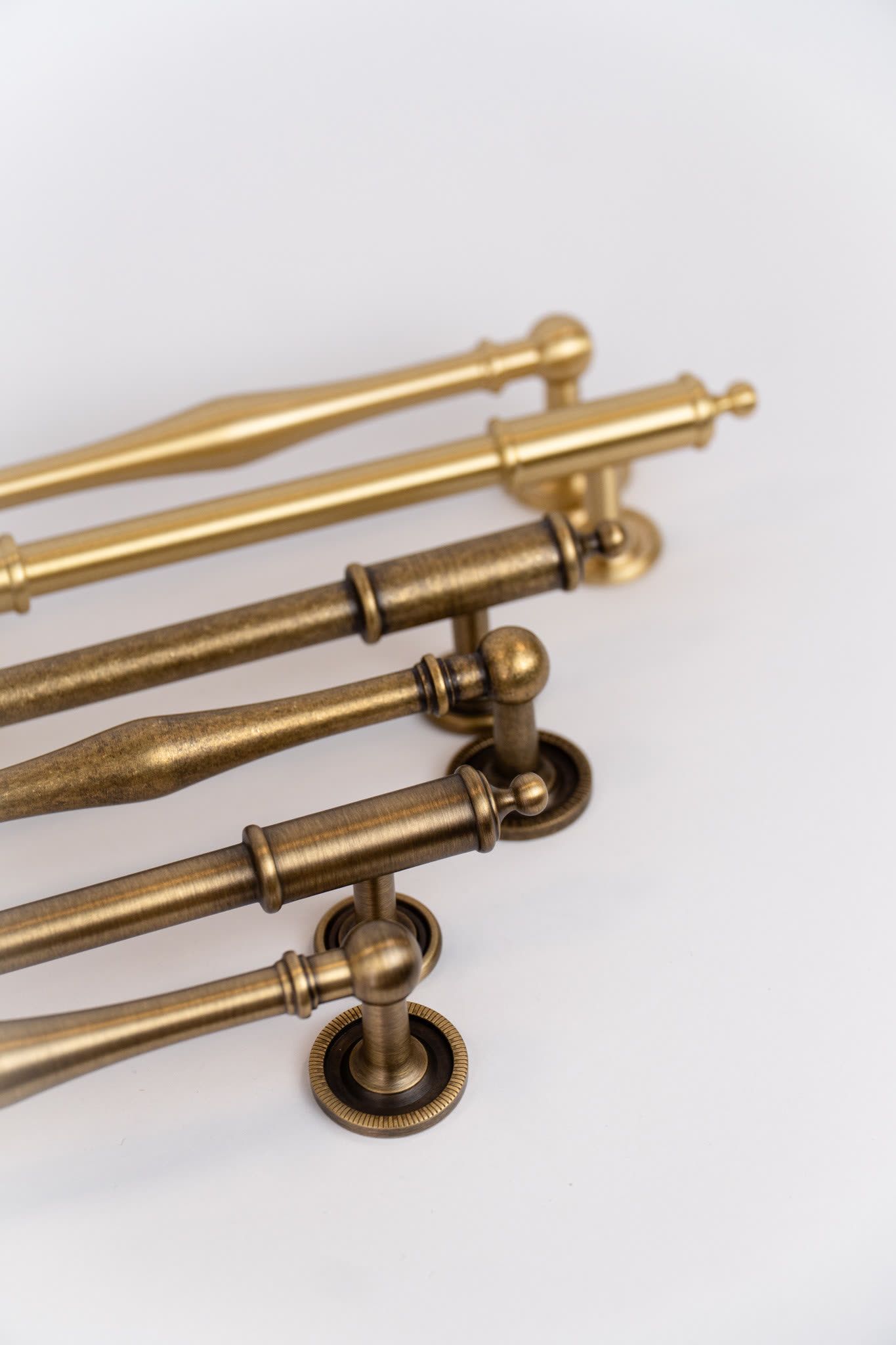 Brass pull handles laid out in a row
