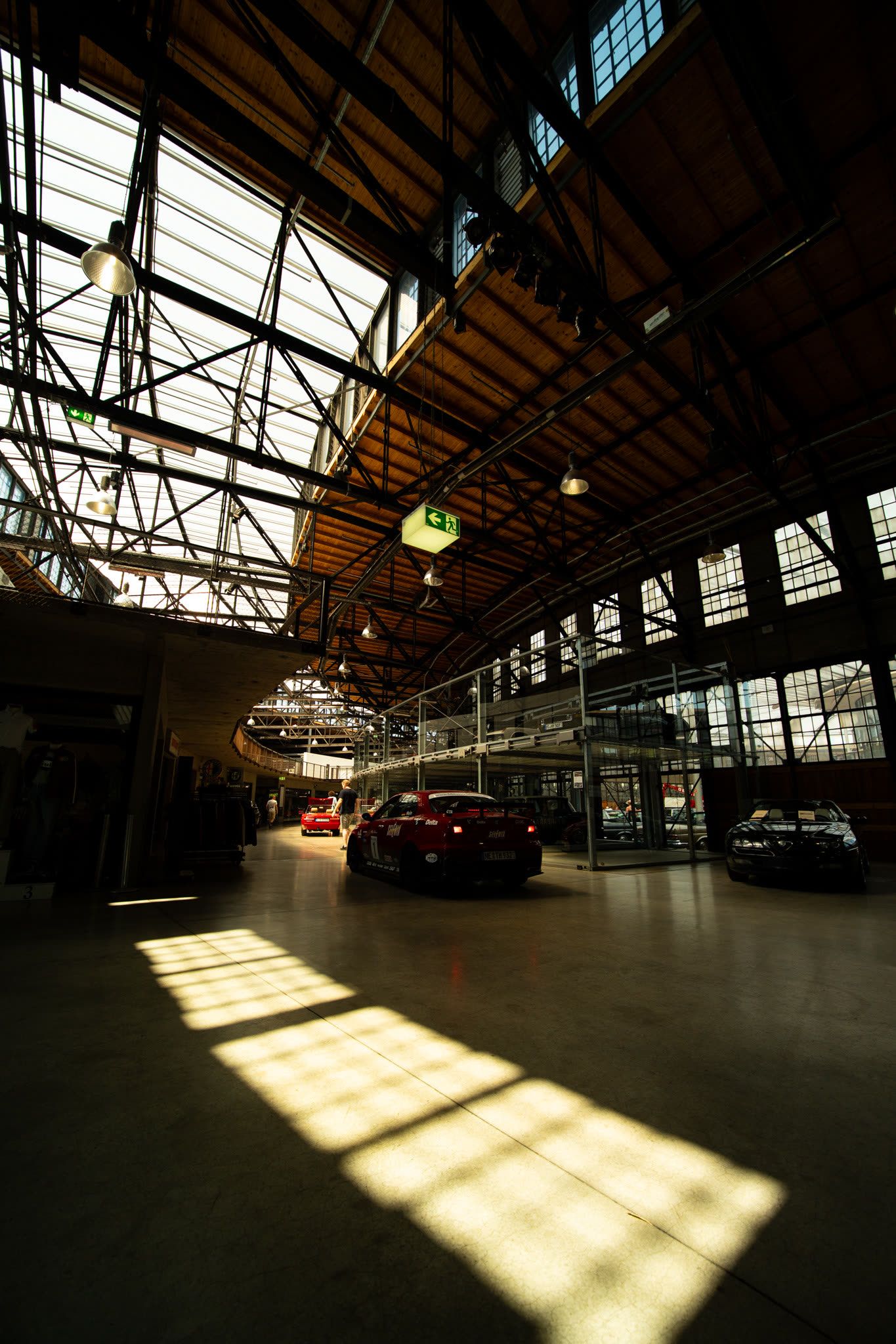 Cars inside an industrial hall with dramatic window light