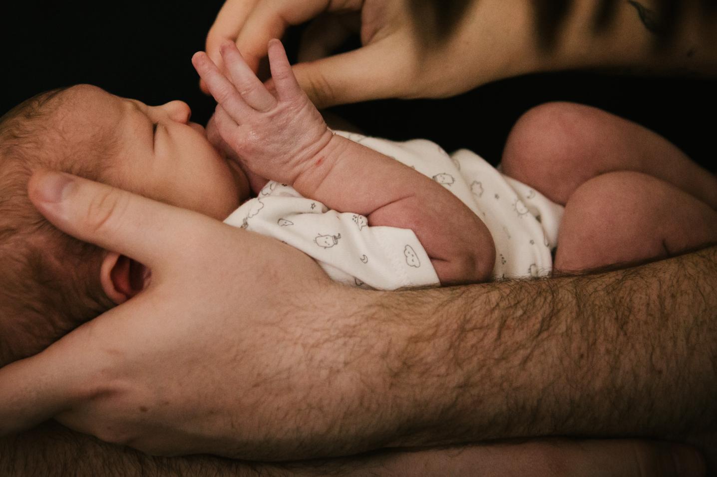 newborn in dad's arms. Pinellas newborn photographer