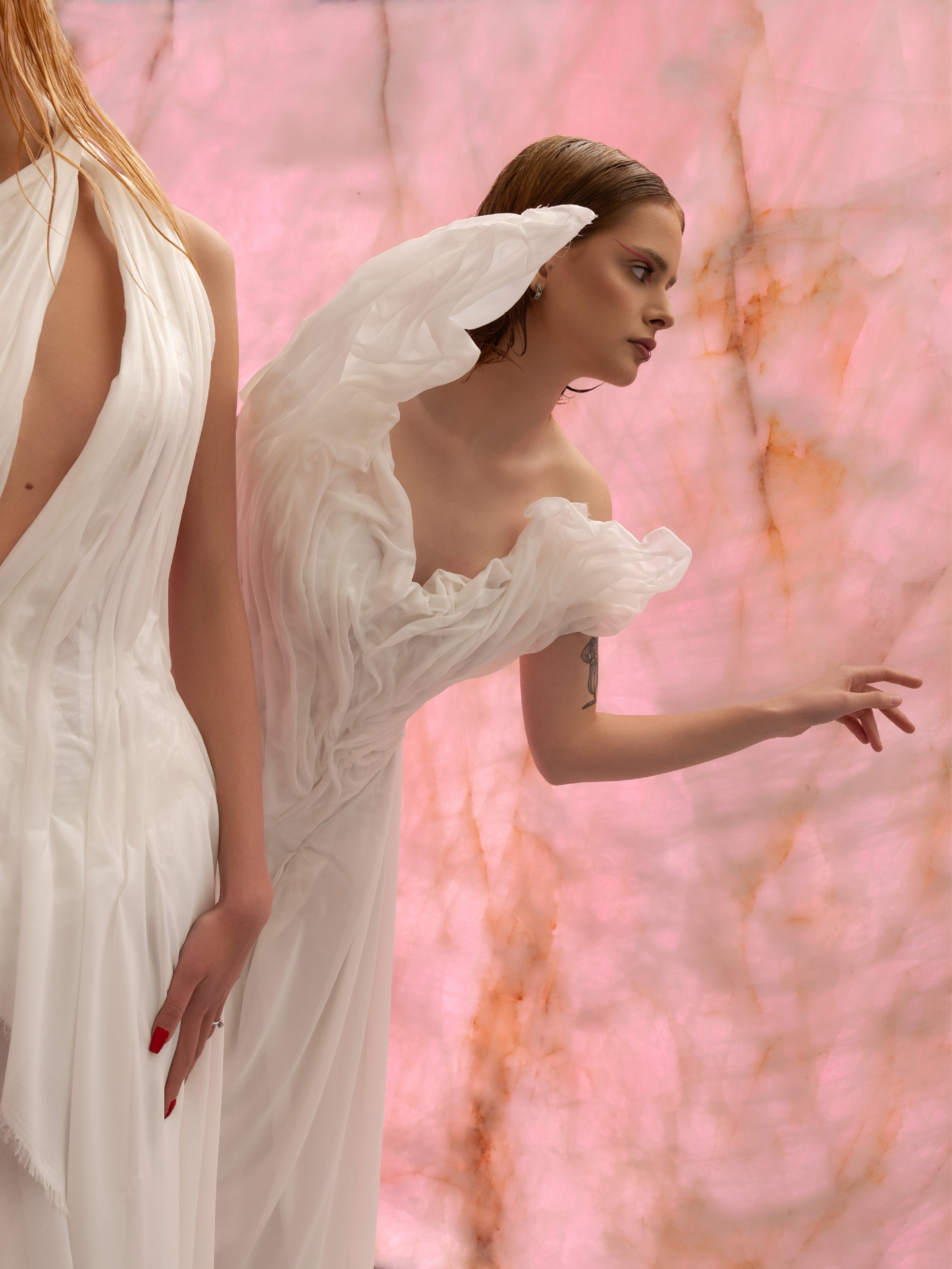 Italstone sculptural white gown against pink onyx surface — Shot in Stone | BoldCrest