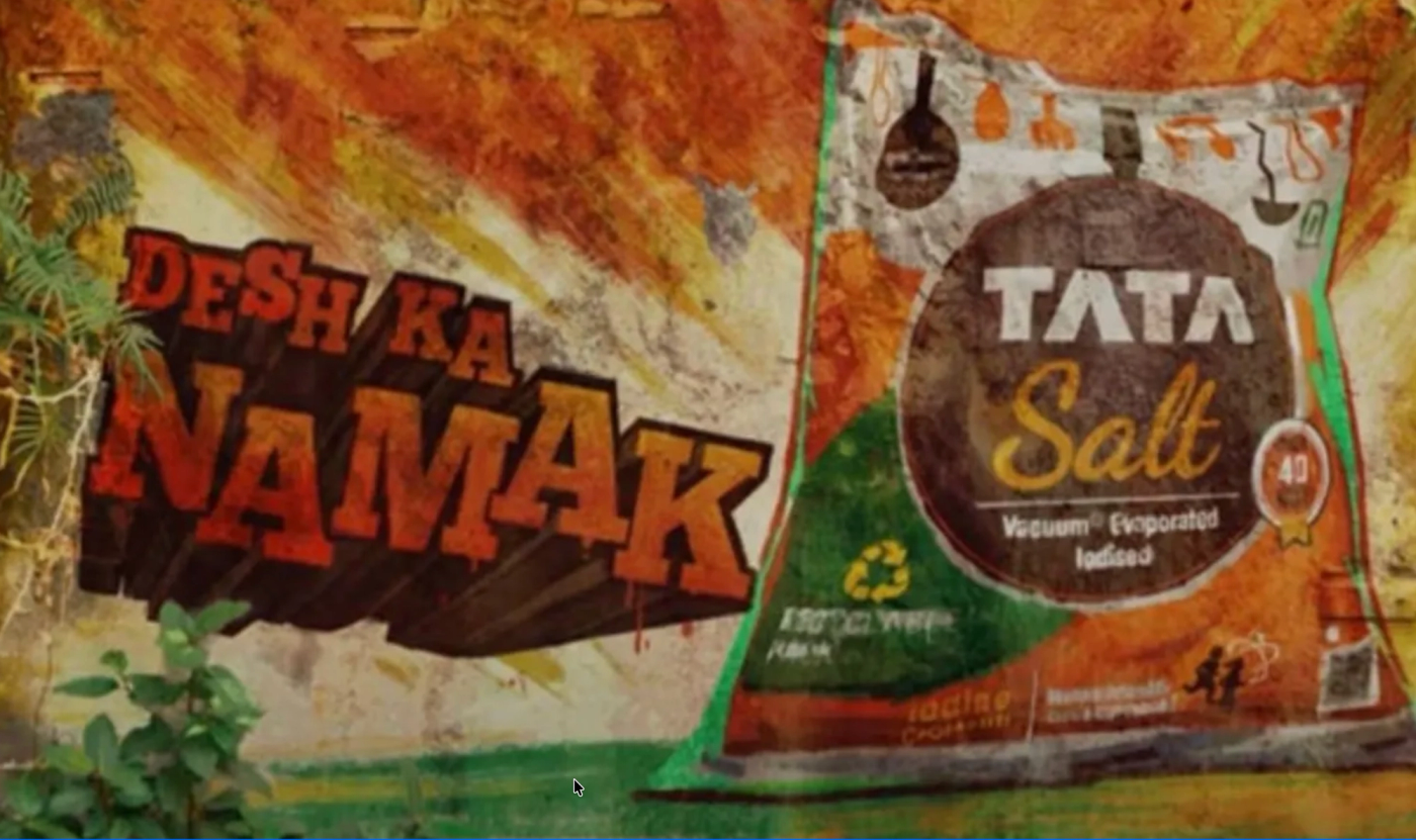 Tata Salt packaging in brown and orange colors with "Desh ka Namak" branding displayed next to street art mural showing Indian cultural elements and orange/green colors representing the Indian flag