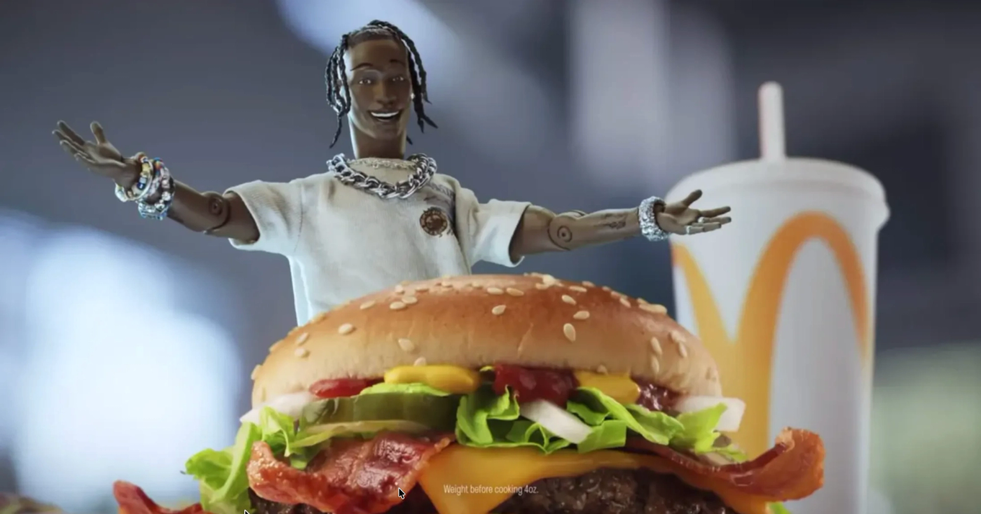 3D animated character in white t-shirt and chain necklace with arms spread wide celebrating in front of a burger with lettuce, tomato, and sesame seeds, McDonald's cup blurred in background