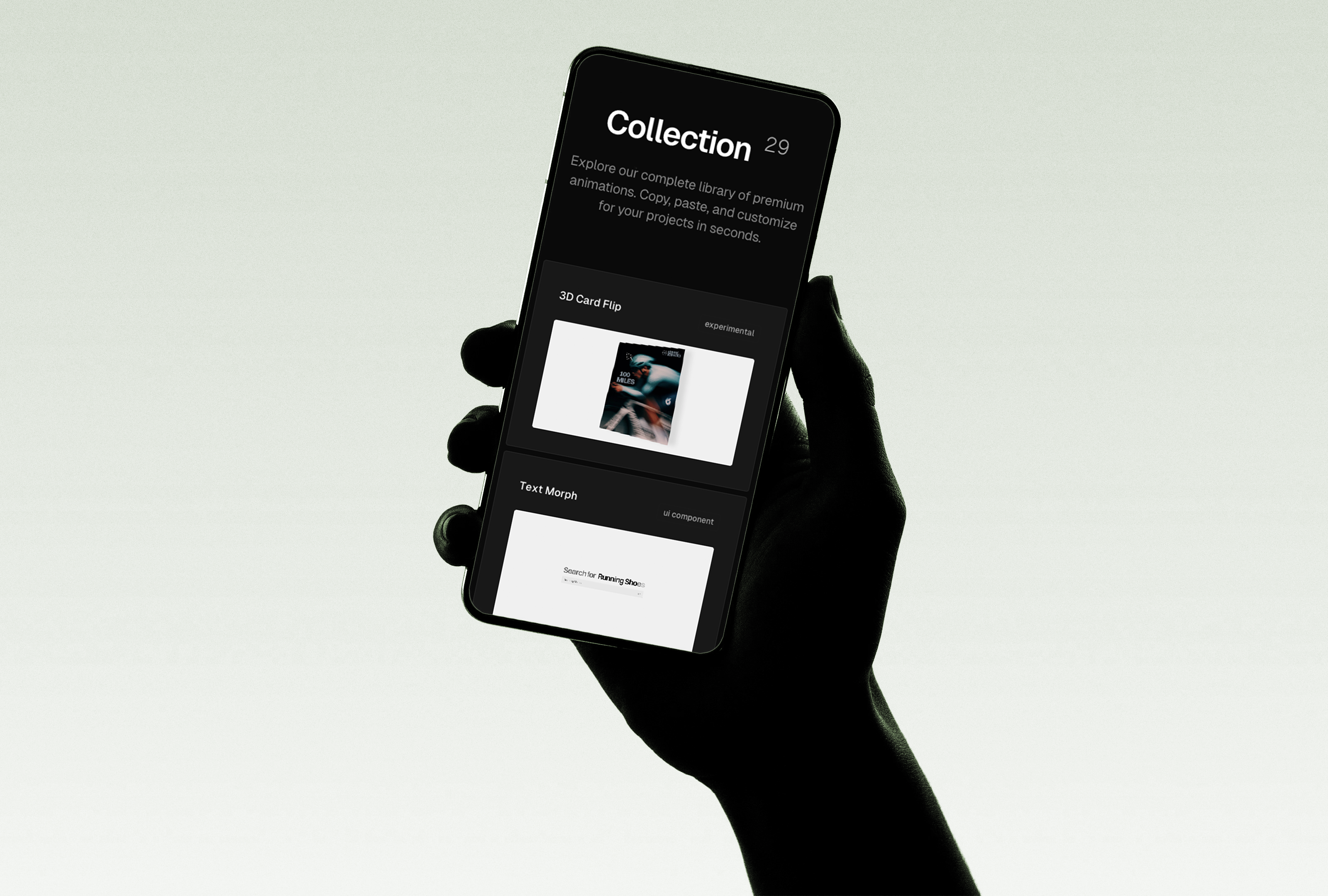Silhouetted hand holding a smartphone displaying the Annnimate collection screen with animation previews