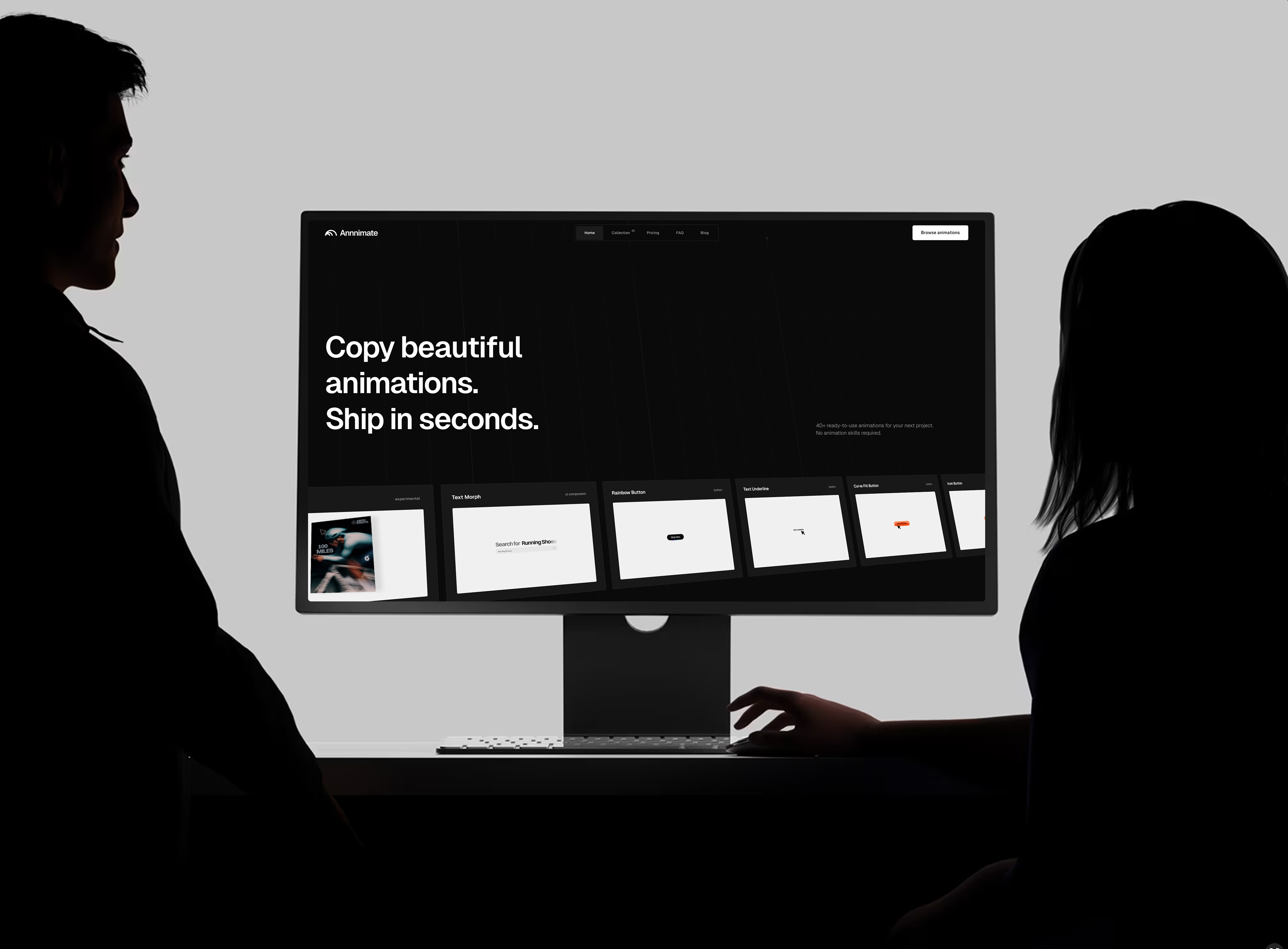 Two silhouetted people viewing the Annnimate website on a large desktop screen displaying an animation library and headline text