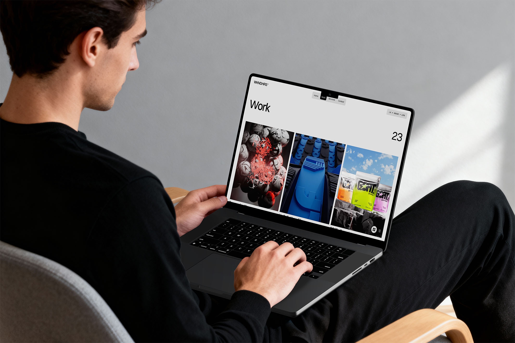 WKNDHRS portfolio website displayed on a laptop, showcasing a grid-based work gallery with bold visuals and minimalist interface