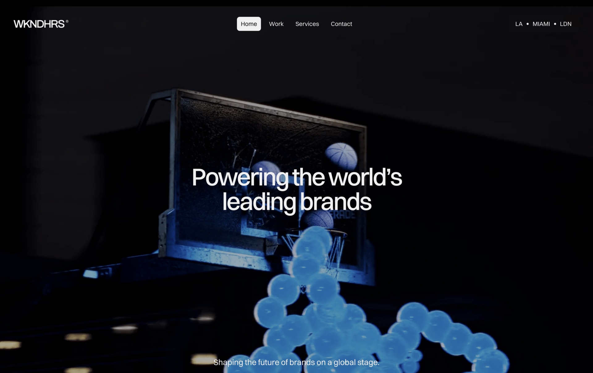 WKNDHRS homepage hero section featuring a dark, cinematic basketball installation with the headline “Powering the world’s leading brands”