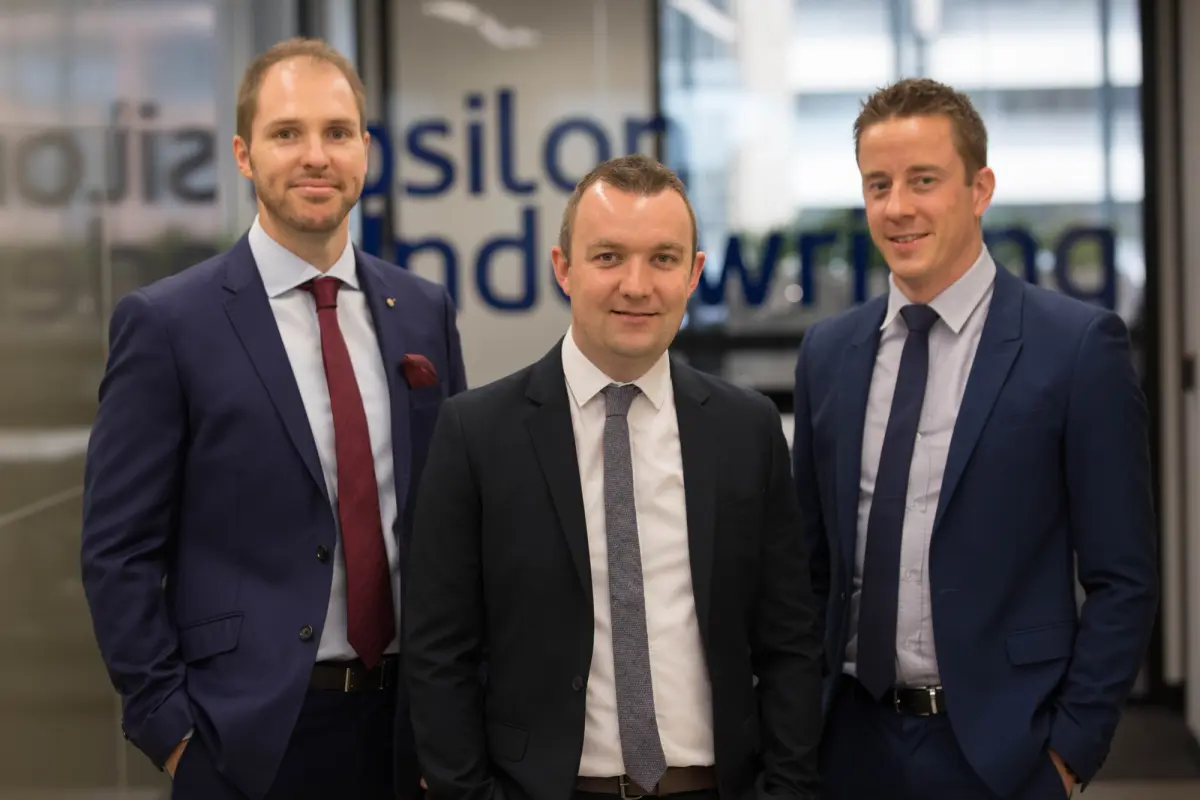 Woman on laptop with workers