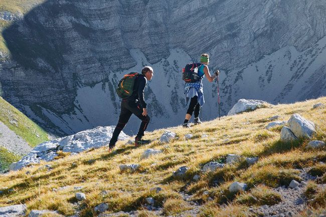 Two People Hiking Up a Mountain | IDID Orthopedics