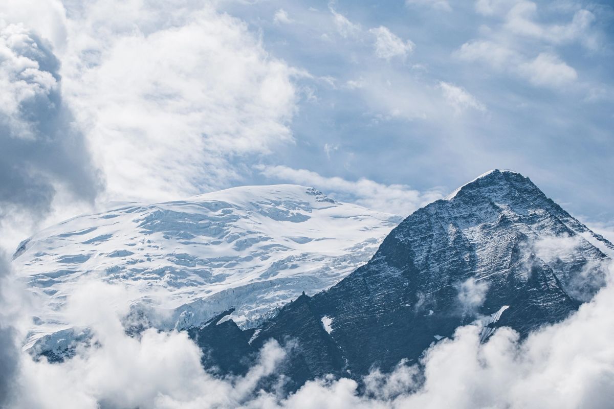 El Dôme y la Aiguille du Goûter del macizo del Mont Blanc entre nubes, vistos desde Merlet