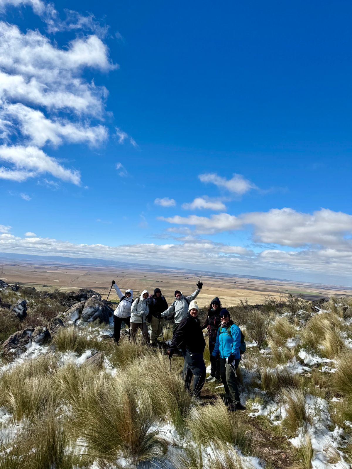 Trekkers caminando por el filón del Morro bajo un cielo azul con nubes