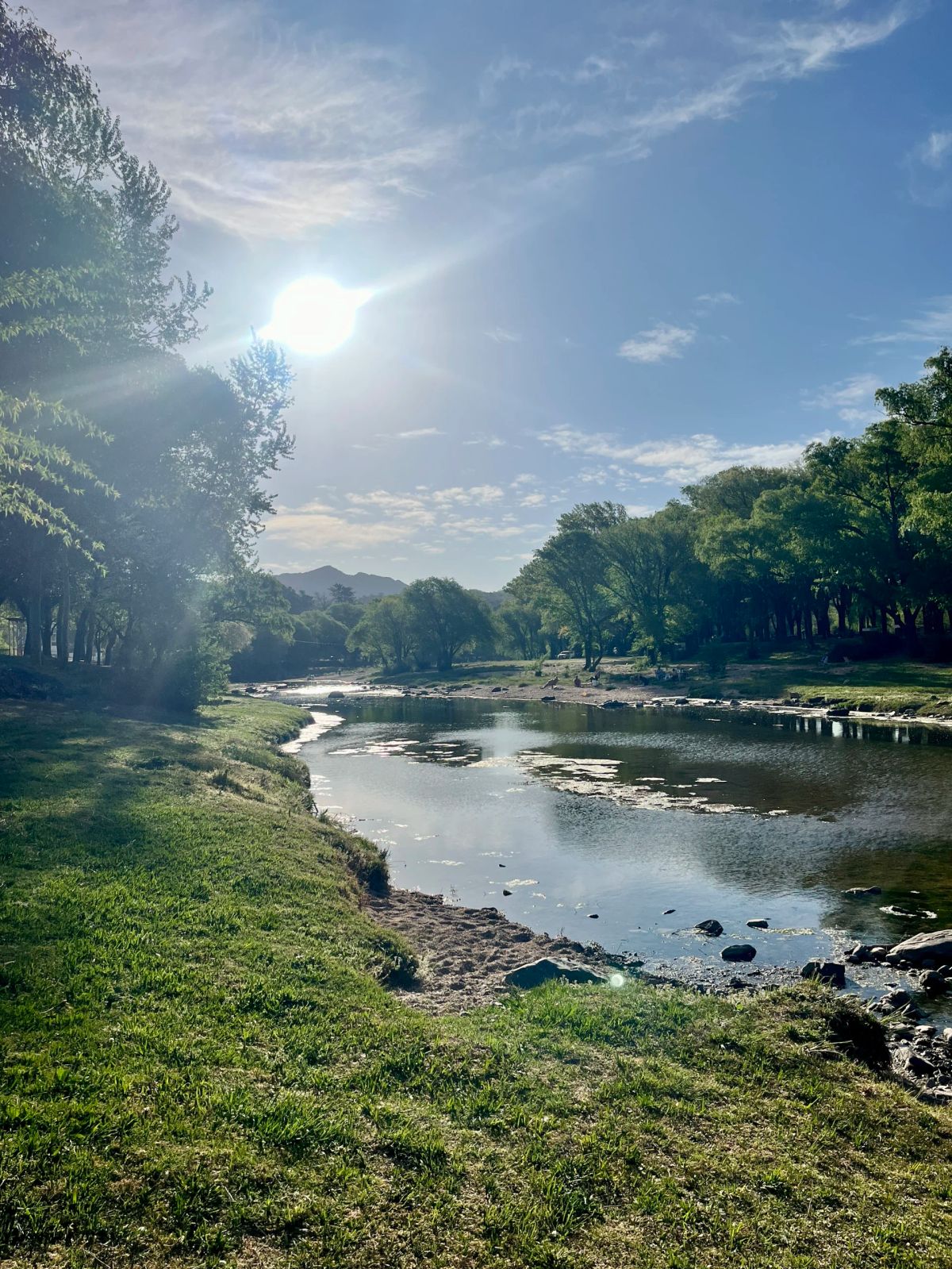 Río de Alpa Corral a contraluz entre la vegetación serrana, al final de la jornada