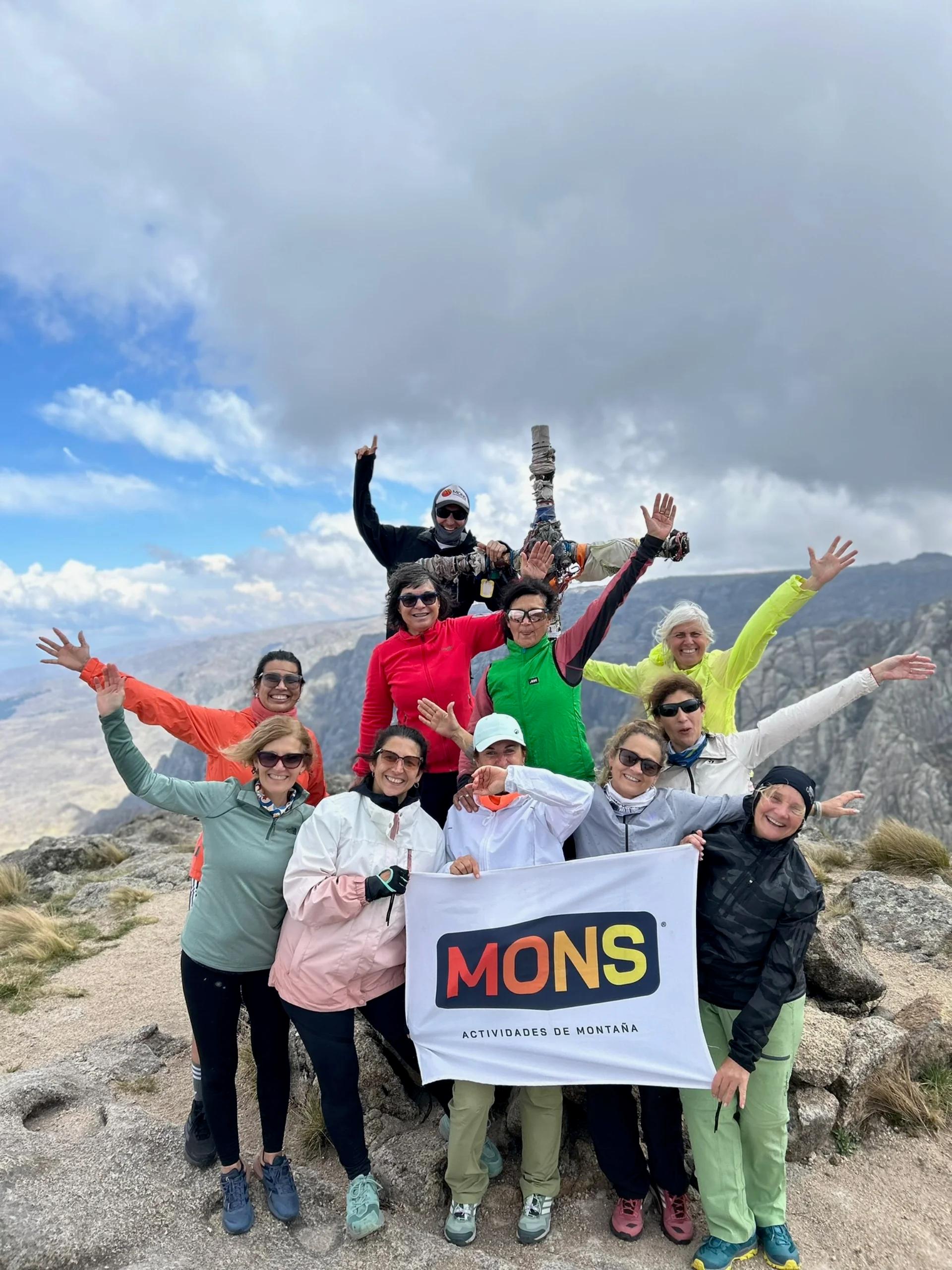 El grupo completo de la Salida 189 con la bandera de Mons en la cumbre de Los Gigantes