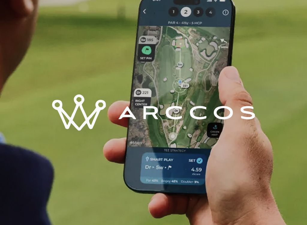 Arccos logo over a hand holding a phone showing a golf hole GPS map